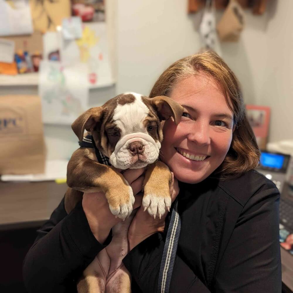 A team member holding a puppy 